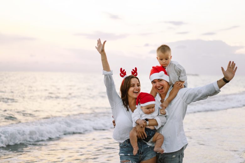 Family in a red Santa hat walk on the beach Family celebrate Christmas and new year at tropics » Crown Paradise
